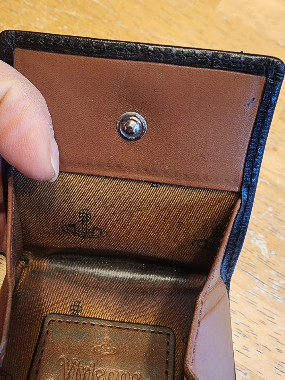 leather Vivienne Westwood coin case features an embossed logo patch on the